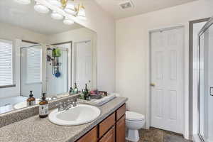 Bathroom featuring a shower stall, vanity, and a bath