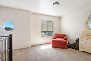 Living area with carpet flooring and baseboards