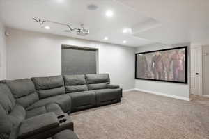 Home theater with light colored carpet and recessed lighting