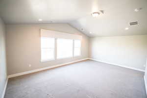 Additional living space featuring vaulted ceiling, carpet floors, and recessed lighting