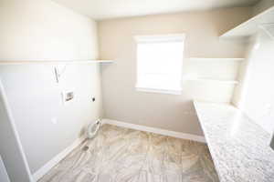Laundry area featuring hookup for a washing machine and electric dryer hookup