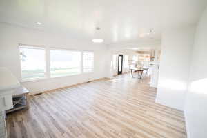 Unfurnished living room with light wood finished floors and recessed lighting
