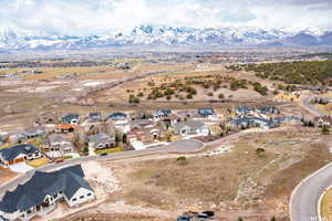 Aerial overview of property's location with a mountainous background and nearby suburban area