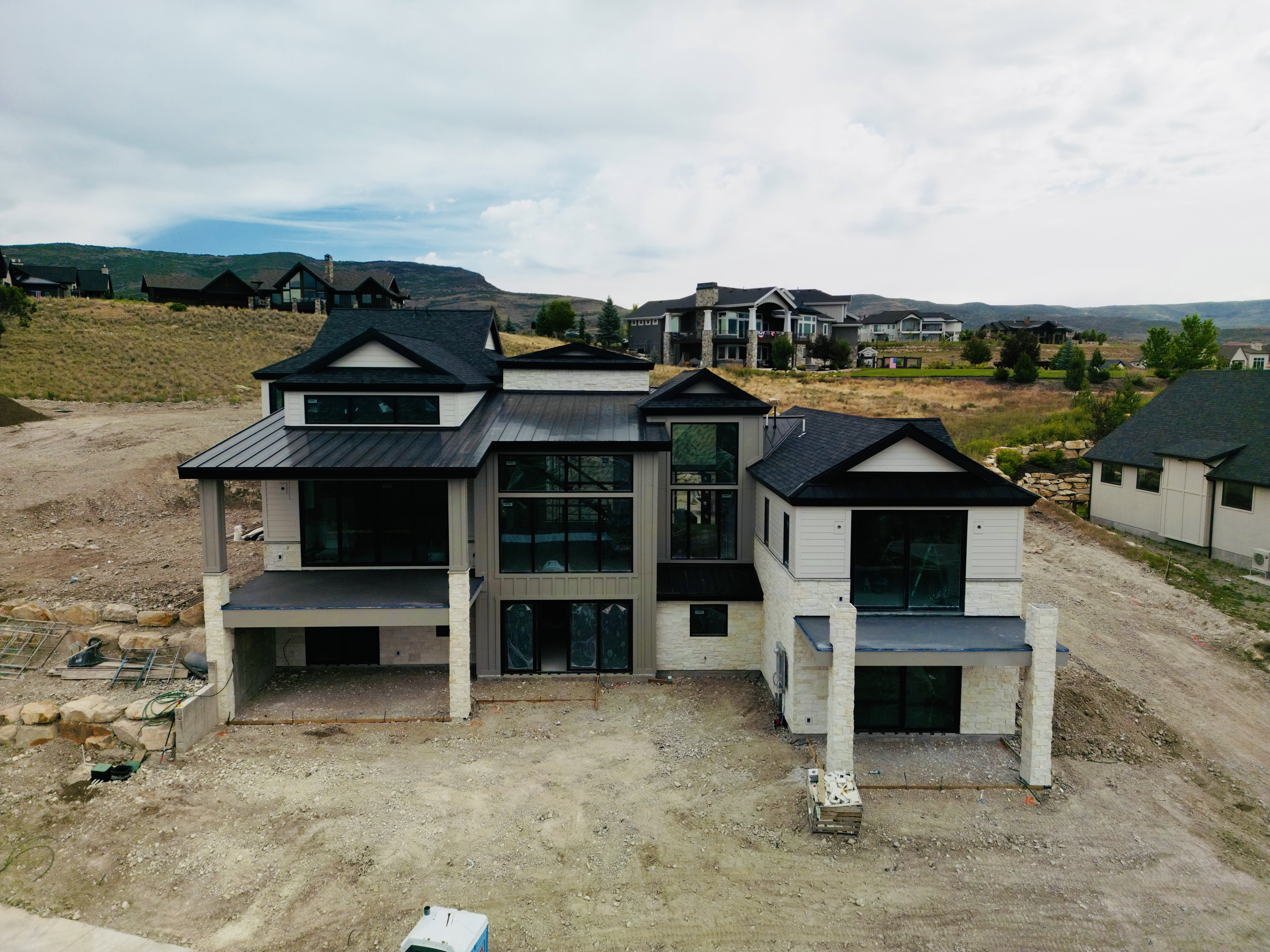 Contemporary new construction featuring a multi-level design with a stone and siding exterior