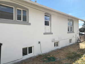 View of property exterior with stucco siding
