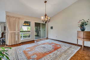 Dining area with a chandelier and vaulted ceiling