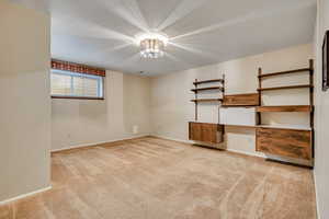 Third bedroom featuring light carpet and baseboards