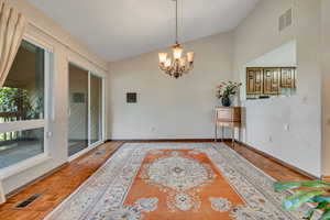 Dining room with lofted ceiling and a chandelier