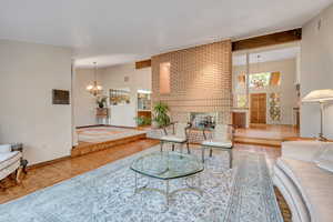 Living area featuring a fireplace and vaulted ceiling