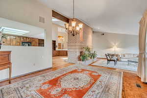 Dining room featuring beam ceiling, a chandelier, and high vaulted ceiling