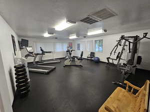 Workout area featuring a textured ceiling