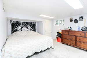 Bedroom featuring light carpet and a textured ceiling