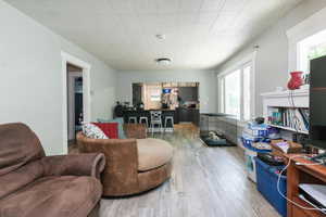 Living area featuring wood finished floors and a desk