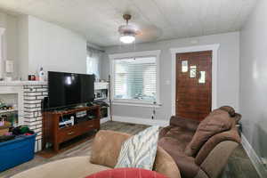 Living area featuring wood finished floors and a ceiling fan