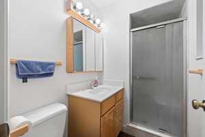 Full bath featuring vanity and a stall shower