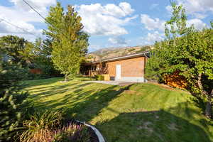 View of yard featuring a patio and a mountain view