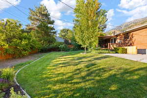 View of yard featuring a deck with mountain view