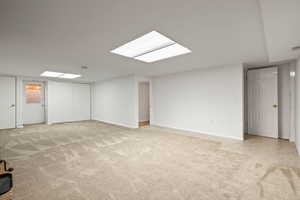 Below grade area featuring light colored carpet