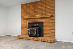 Detailed view of a wood stove and carpet flooring