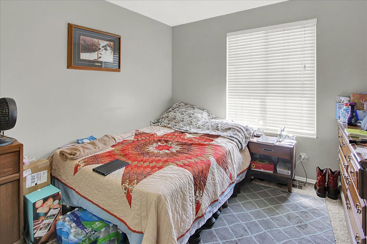 Bedroom with light carpet and baseboards