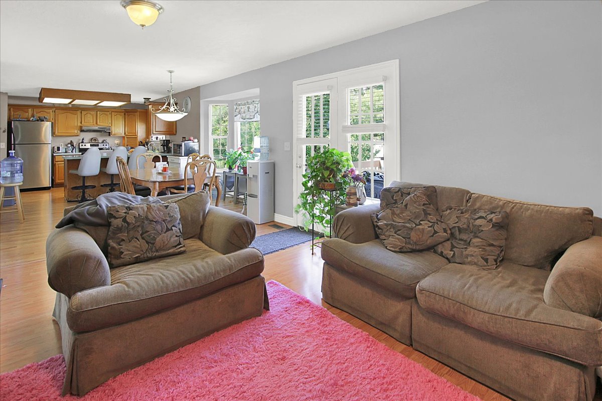 Living room with light wood finished floors and baseboards
