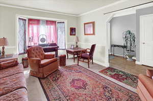 Living area with ornamental molding and a textured ceiling