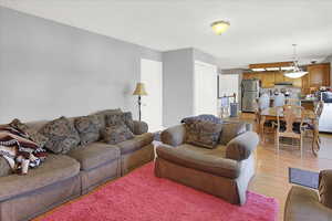 Living room with light wood-style flooring