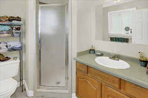 Full bathroom with a stall shower, vanity, and light tile patterned flooring