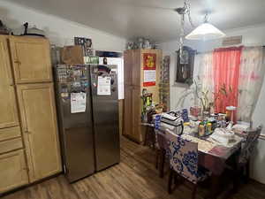 Dining space with dark wood-style floors and ornamental molding