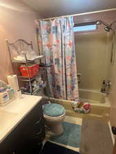 Full bathroom with shower / tub combo, vanity, and tile patterned flooring