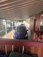 View of parking with an attached carport