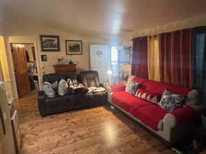 Living room featuring a textured ceiling and wood finished floors