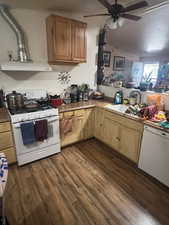 Kitchen with white appliances, dark wood-style floors, a ceiling fan, a textured ceiling, and light countertops