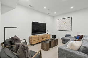 Living room with recessed lighting and carpet flooring