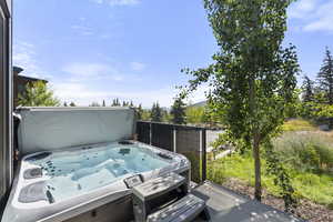 View of patio featuring a hot tub