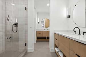 Full bathroom featuring vanity, a shower stall, and light tile patterned flooring