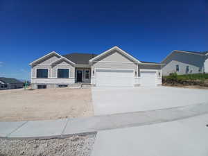 View of front of home with board and batten siding, a garage, concrete driveway, and covered porch