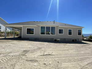 Rear view of house with a shingled roof