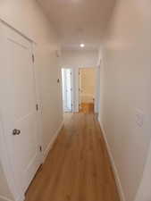 Hallway featuring light wood-style floors and recessed lighting