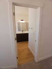Corridor featuring baseboards and light wood-style floors