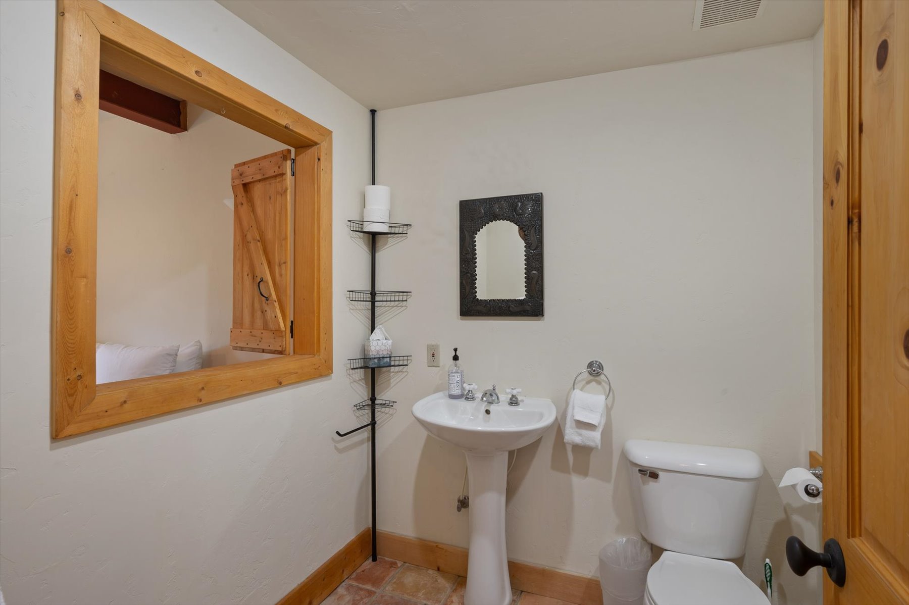 Apartment bathroom featuring Saltillo tiled floors and jetted tub and shower