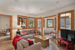 The lower level family room has a stone faced wood burning fireplace and offers wonderful views