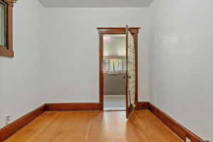 Unfurnished room featuring light wood-style flooring and baseboards