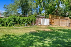 Fenced backyard with a storage unit
