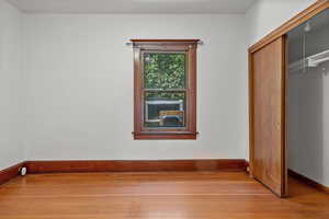 Unfurnished bedroom featuring light wood-style floors and a closet
