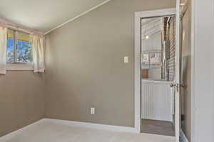 Carpeted spare room with baseboards