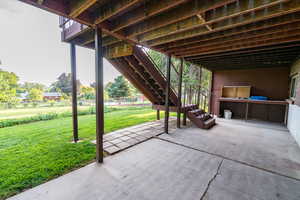 View of patio featuring stairway and a deck