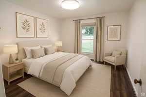 Bedroom with wood finished floors and baseboards