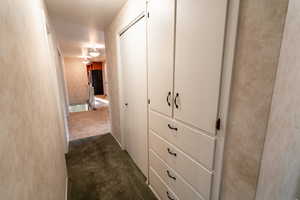 Corridor with dark colored carpet