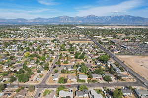 Aerial view of property's location featuring a mountainous background and nearby suburban area